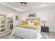 Well-lit bedroom with a decorative rug, lamps on the nightstands, and a view into the en-suite bath at 7758 Summerland Cv, Bradenton, FL 34202