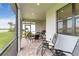 Relaxing screened patio with comfortable seating, a grill, and peaceful views of the surrounding landscape at 7758 Summerland Cv, Bradenton, FL 34202