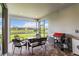 Cozy screened patio with comfortable seating, outdoor grill, and serene water views, ideal for relaxation at 7758 Summerland Cv, Bradenton, FL 34202