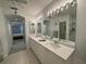 Bright bathroom features dual sinks, tiled floors, and a walk-in shower for a spa-like experience at 8616 15Th Nw Ave, Bradenton, FL 34209