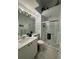 Modern bathroom with a glass-enclosed shower, vanity and mirror with overhead lighting at 8616 15Th Nw Ave, Bradenton, FL 34209