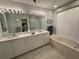Bright main bathroom with double sinks, a soaking tub, and well-lit vanity for comfort and convenience at 8616 15Th Nw Ave, Bradenton, FL 34209