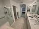 Well-lit bathroom showcasing dual sinks, modern fixtures, and a walk-in shower for a luxurious experience at 8616 15Th Nw Ave, Bradenton, FL 34209