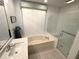 Bright bathroom featuring a soaking tub and separate glass-enclosed shower for a spa-like experience at 8616 15Th Nw Ave, Bradenton, FL 34209