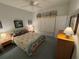 Cozy bedroom with a ceiling fan, two side tables and a comfortable queen-size bed at 8616 15Th Nw Ave, Bradenton, FL 34209