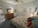 Charming bedroom featuring a ceiling fan, a queen-size bed and a dresser with an adjacent closet at 8616 15Th Nw Ave, Bradenton, FL 34209
