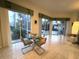 Bright breakfast nook with glass table set and sliding glass doors offering views of the lanai and landscaped yard at 8616 15Th Nw Ave, Bradenton, FL 34209