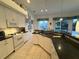 Bright kitchen features white cabinetry, granite countertops, tile flooring, and modern appliances at 8616 15Th Nw Ave, Bradenton, FL 34209