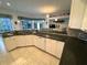 Kitchen featuring bright white cabinetry, granite countertops, modern appliances, and tile flooring at 8616 15Th Nw Ave, Bradenton, FL 34209