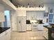 Bright kitchen features white cabinetry, modern appliances, and a view into the dining room at 8616 15Th Nw Ave, Bradenton, FL 34209