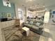Bright living room features tile flooring, modern furnishings, and a view into the kitchen at 8616 15Th Nw Ave, Bradenton, FL 34209