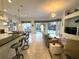 Open living room with tile flooring, wet bar, comfortable seating and serene views of the pool and backyard at 8616 15Th Nw Ave, Bradenton, FL 34209