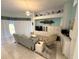 Living room featuring neutral colors, tile floors, modern furniture, and large light-filtering windows at 8616 15Th Nw Ave, Bradenton, FL 34209