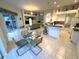 Open-concept living space with kitchen, dining, and living areas and sliding glass door to the outdoors at 8616 15Th Nw Ave, Bradenton, FL 34209