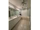Bathroom featuring dual sinks, a wide mirror with attractive lighting, and a soaking tub with a large window at 8616 15Th Nw Ave, Bradenton, FL 34209