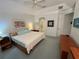 Large, bright main bedroom with a ceiling fan, bedside tables, and neutral decor at 8616 15Th Nw Ave, Bradenton, FL 34209
