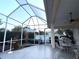 Enclosed patio with outdoor table set, ceiling fan, and ample space for relaxation and entertaining at 8616 15Th Nw Ave, Bradenton, FL 34209