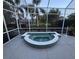 Enclosed patio shows tiled hot tub spa, with ample space for relaxation and privacy landscaping at 8616 15Th Nw Ave, Bradenton, FL 34209