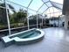Enclosed patio shows tiled hot tub spa, with ample space for relaxation and privacy landscaping at 8616 15Th Nw Ave, Bradenton, FL 34209