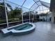 Enclosed patio shows tiled hot tub spa, with ample space for relaxation and privacy landscaping at 8616 15Th Nw Ave, Bradenton, FL 34209