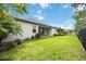 A spacious backyard with lush green grass and a black fence, perfect for outdoor entertaining and relaxation at 918 Fernleaf Run, Bradenton, FL 34212