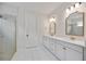 Bathroom featuring double sinks, a glass shower, and attractive lighting at 918 Fernleaf Run, Bradenton, FL 34212