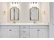 Bathroom featuring double vanity with gold fixtures and gold-trimmed mirrors at 918 Fernleaf Run, Bradenton, FL 34212