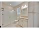 Well-lit bathroom features a glass-enclosed shower and vanity with granite counters at 918 Fernleaf Run, Bradenton, FL 34212