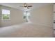This light and bright bedroom is spacious and airy with multiple windows and neutral carpet at 918 Fernleaf Run, Bradenton, FL 34212