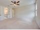 Spacious bedroom with en-suite bathroom access, a ceiling fan and neutral carpeting at 918 Fernleaf Run, Bradenton, FL 34212