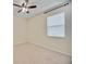 Neutral bedroom features carpeted floors, a ceiling fan, and a bright window at 918 Fernleaf Run, Bradenton, FL 34212