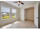 Light bedroom featuring wood floors, two windows, and an attached closet at 918 Fernleaf Run, Bradenton, FL 34212