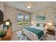 Comfortable bedroom with floral wallpaper, white trim, natural light, and stylish decor at 918 Fernleaf Run, Bradenton, FL 34212
