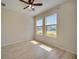Light-filled bedroom with wood floors, two windows, and great natural light at 918 Fernleaf Run, Bradenton, FL 34212