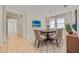 Dining room with an oval table, six chairs, and natural light from the windows at 918 Fernleaf Run, Bradenton, FL 34212