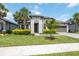 Inviting single-story home featuring a well-maintained lawn and tropical landscaping at 918 Fernleaf Run, Bradenton, FL 34212