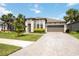 Stunning single-story home with a two-car garage, landscaped front yard, and beautiful palm trees at 918 Fernleaf Run, Bradenton, FL 34212
