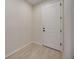 Hallway featuring light wood floors and a white door at 918 Fernleaf Run, Bradenton, FL 34212
