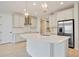 Open kitchen with an island, modern appliances, and stylish lighting fixtures and lots of space at 918 Fernleaf Run, Bradenton, FL 34212