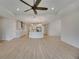 Open-concept living room showcasing the kitchen with stainless steel appliances and center island at 918 Fernleaf Run, Bradenton, FL 34212