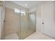 Walk-in shower featuring glass door and beige tiling at 918 Fernleaf Run, Bradenton, FL 34212