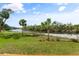 Scenic water view featuring lush greenery, palm trees, and serene river, enhancing the property's natural beauty at 918 Fernleaf Run, Bradenton, FL 34212