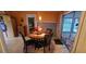 Cozy dining area with wooden table and chairs, complemented by warm lighting and view to a sunroom at 120 Sw Monroe N Cir, St Petersburg, FL 33703