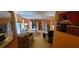 Open living area with hardwood floors, comfortable seating, a TV, and views of the dining room at 120 Sw Monroe N Cir, St Petersburg, FL 33703