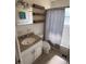 Bathroom with new shelves, a combination shower and tub, and plenty of light at 1224 38Th W St, Bradenton, FL 34205