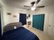 Cozy bedroom with ceiling fan, blue bedding, adjacent to bookcase and closet at 1224 38Th W St, Bradenton, FL 34205