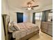 Cozy bedroom with neutral colors, ceiling fan, and matching dresser at 1224 38Th W St, Bradenton, FL 34205