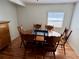 Comfortable dining room featuring wood table and chairs, with natural light from a window at 1224 38Th W St, Bradenton, FL 34205