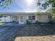 Charming home showcasing a well-maintained exterior with a cozy carport and manicured landscaping at 1224 38Th W St, Bradenton, FL 34205