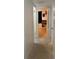 Hallway with terrazzo floor that leads to the bedroom with bookshelves and decorations at 1224 38Th W St, Bradenton, FL 34205
